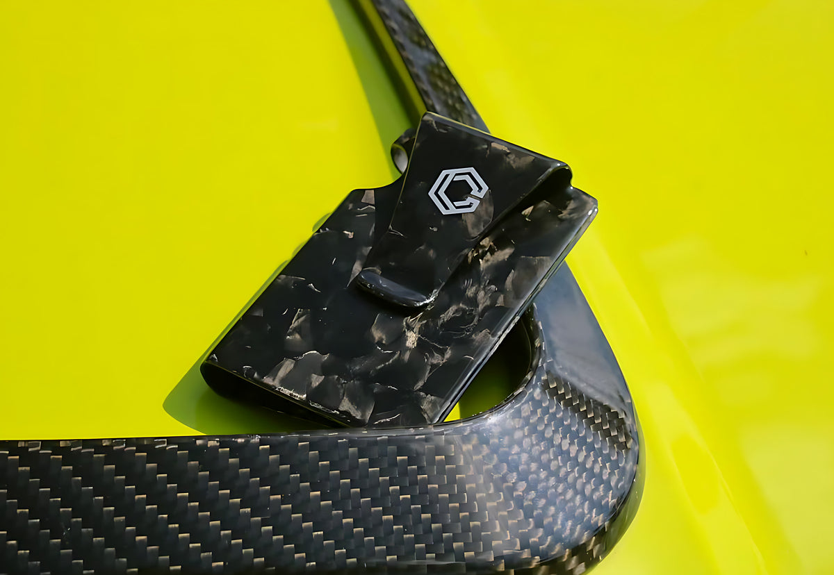 Carboluxe forged carbon wallet on a yellow car