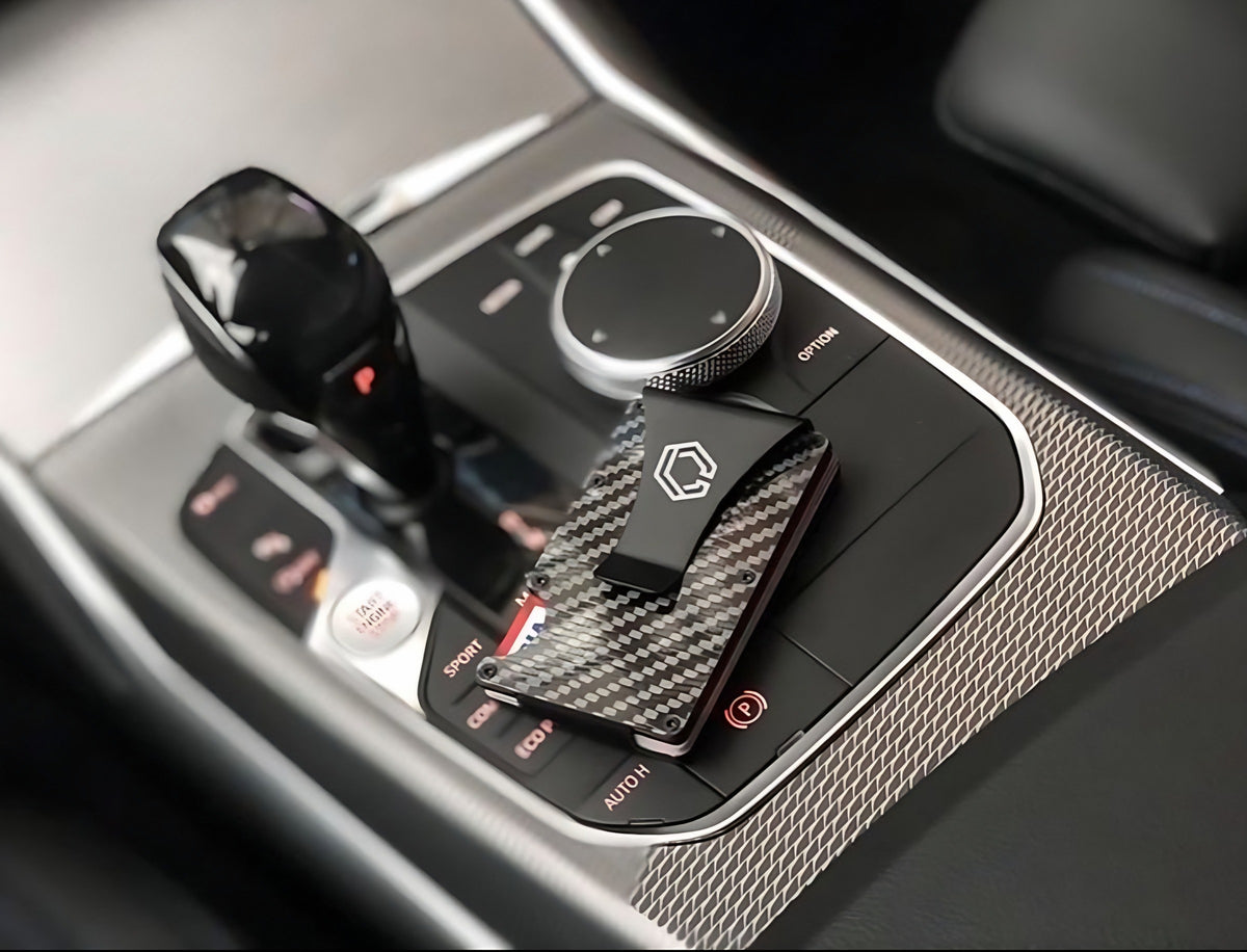 Carboluxe carbon fiber slim wallet on a car center console