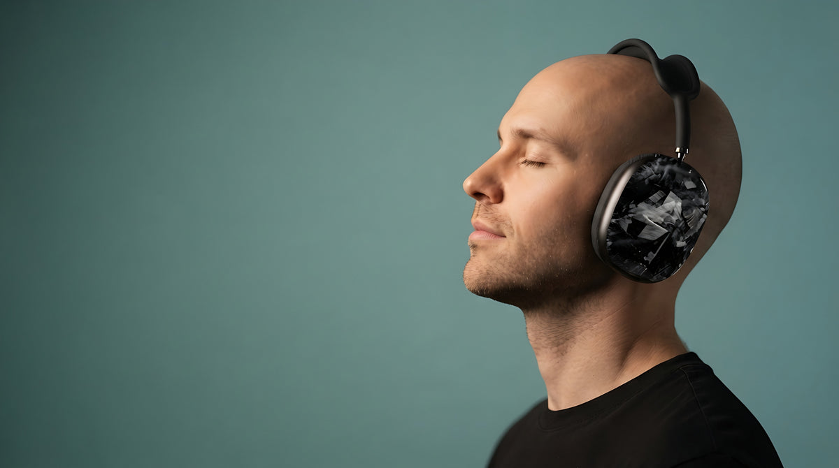 Man wearing headphones with Carboluxe forged carbon ear cup covers